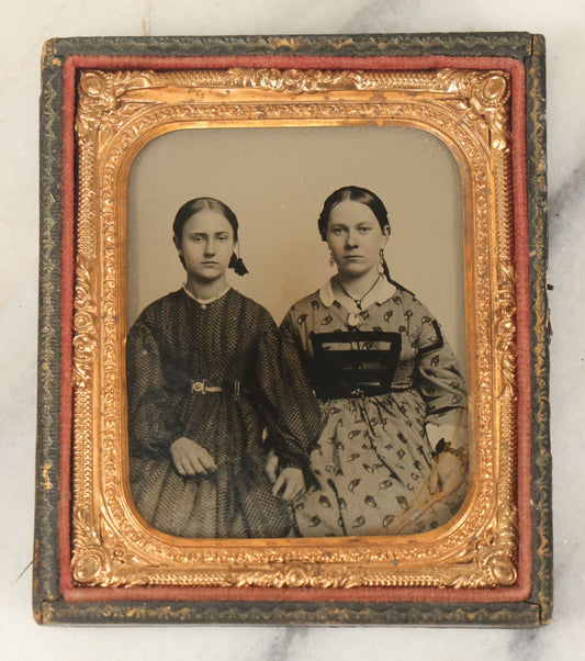 Lot 053 - Antique 1/6th Plate Ambrotype Photograph Of Two Young Women, Likely Sisters, With Linked Hands, Note Wear In Lower Right Corner, In Half Leatherette Case