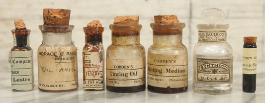 Lot 075 - Grouping Of 7 Antique Glass Bottles For Artists Supplies, Including Tinting Oil, Oil Anise, Lustre, And Others, As Found, Various Manufacturers