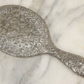 Lot 025 - Antique Silverplate Hand Mirror, Floral Repoussé Design, Beveled Glass, Note Wear To Mirror