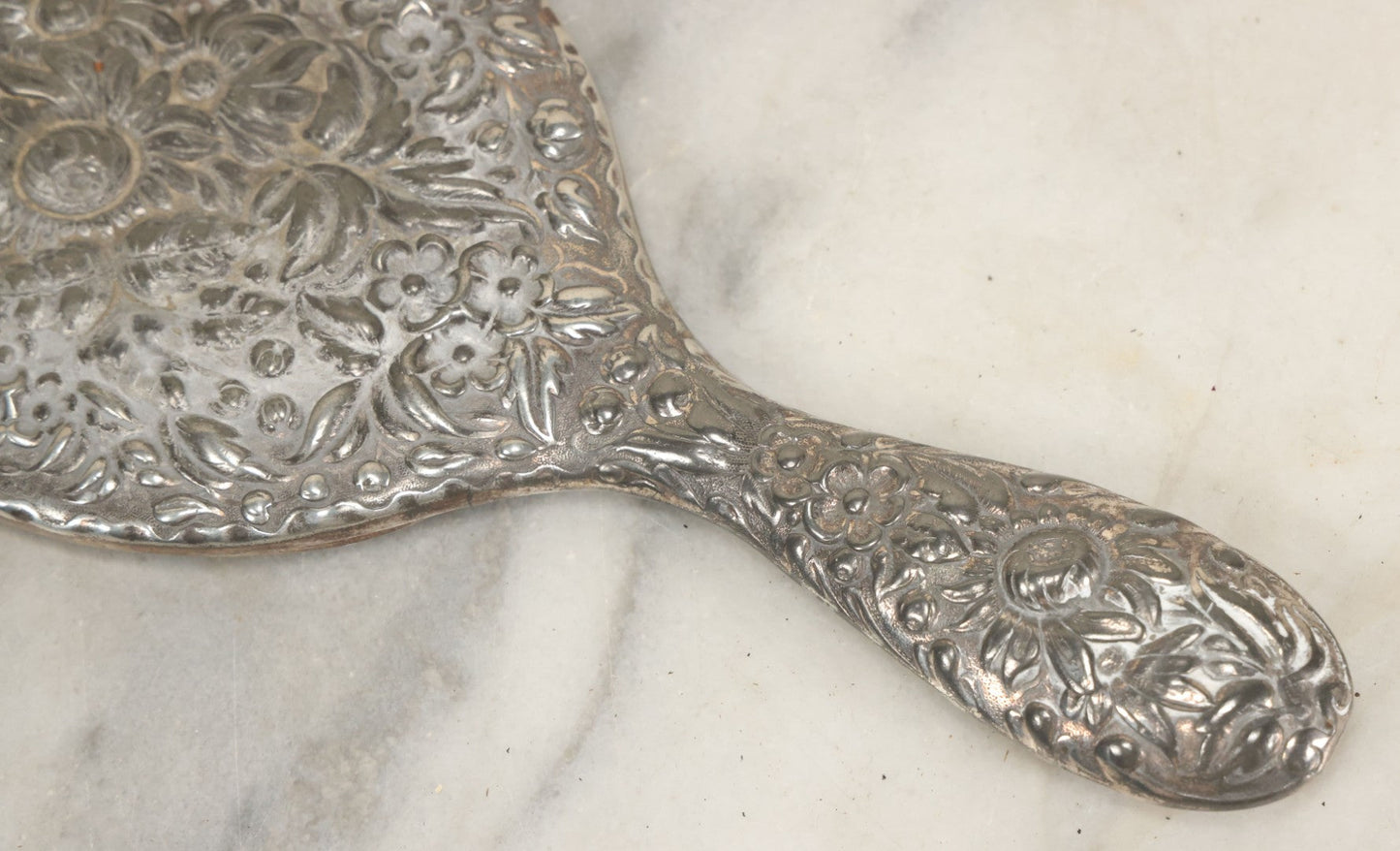 Lot 025 - Antique Silverplate Hand Mirror, Floral Repoussé Design, Beveled Glass, Note Wear To Mirror