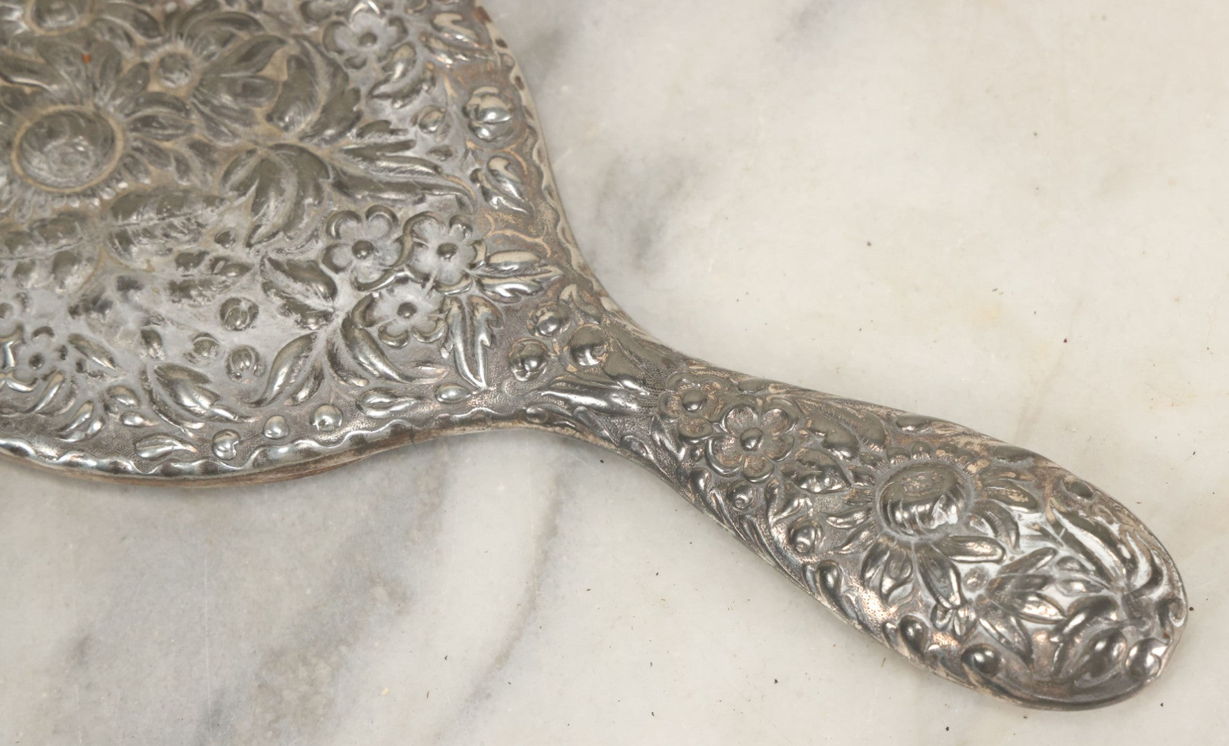 Lot 025 - Antique Silverplate Hand Mirror, Floral Repoussé Design, Beveled Glass, Note Wear To Mirror