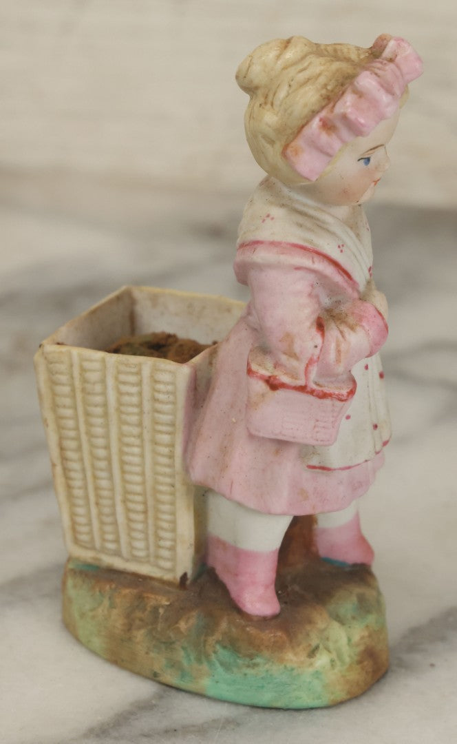 Lot 065 - Antique Hand-Painted Bisque Girl Figural Match Strike, Match Safe, Pink Dress And Bonnet, Likely German