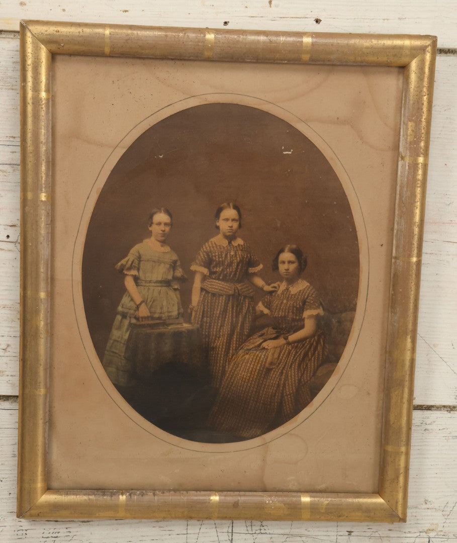 Lot 078 - Antique Framed Hand Tinted Photograph Of Three Young Girls, Likely Sisters, In Dresses, I.D. In Pencil On Verso