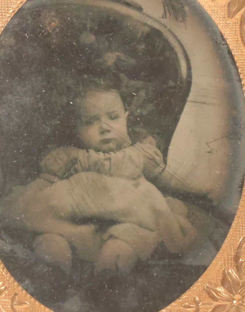 Lot 085 - Antique 1/9th Plate Ruby Ambrotype Photograph Of A Slouching Baby In A Chair