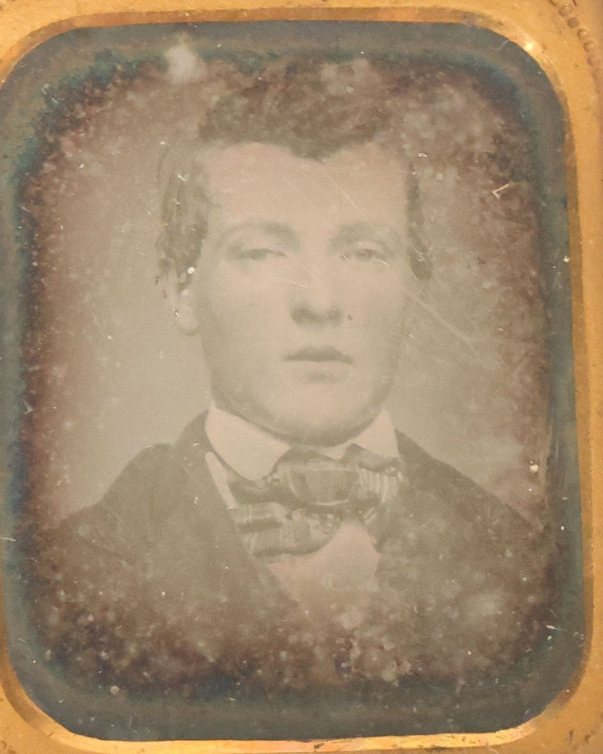 Lot 087 - Antique 1/16th Plate Daguerreotype Of A Young Man In A Bowtie In A Half Leatherette Case