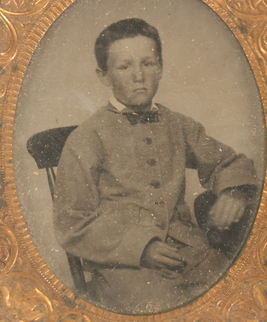 Lot 089 - Antique 1/9th Plate Tintype Photograph Of A Young Boy In A Gray Suit With A Bowtie, In Half Leatherette Case