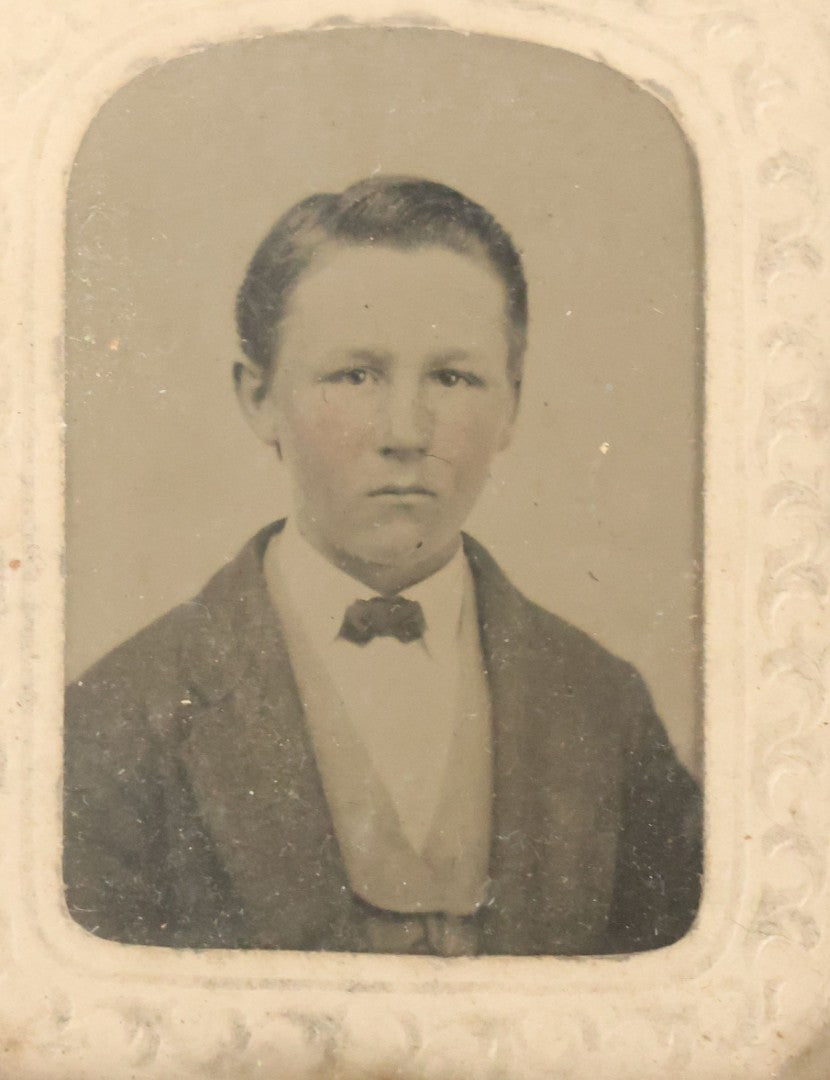 Lot 090 - Antique 1/9th Plate Tintype Photograph Of A Young Boy In A Jacket With A Bowtie, White Paper Mat