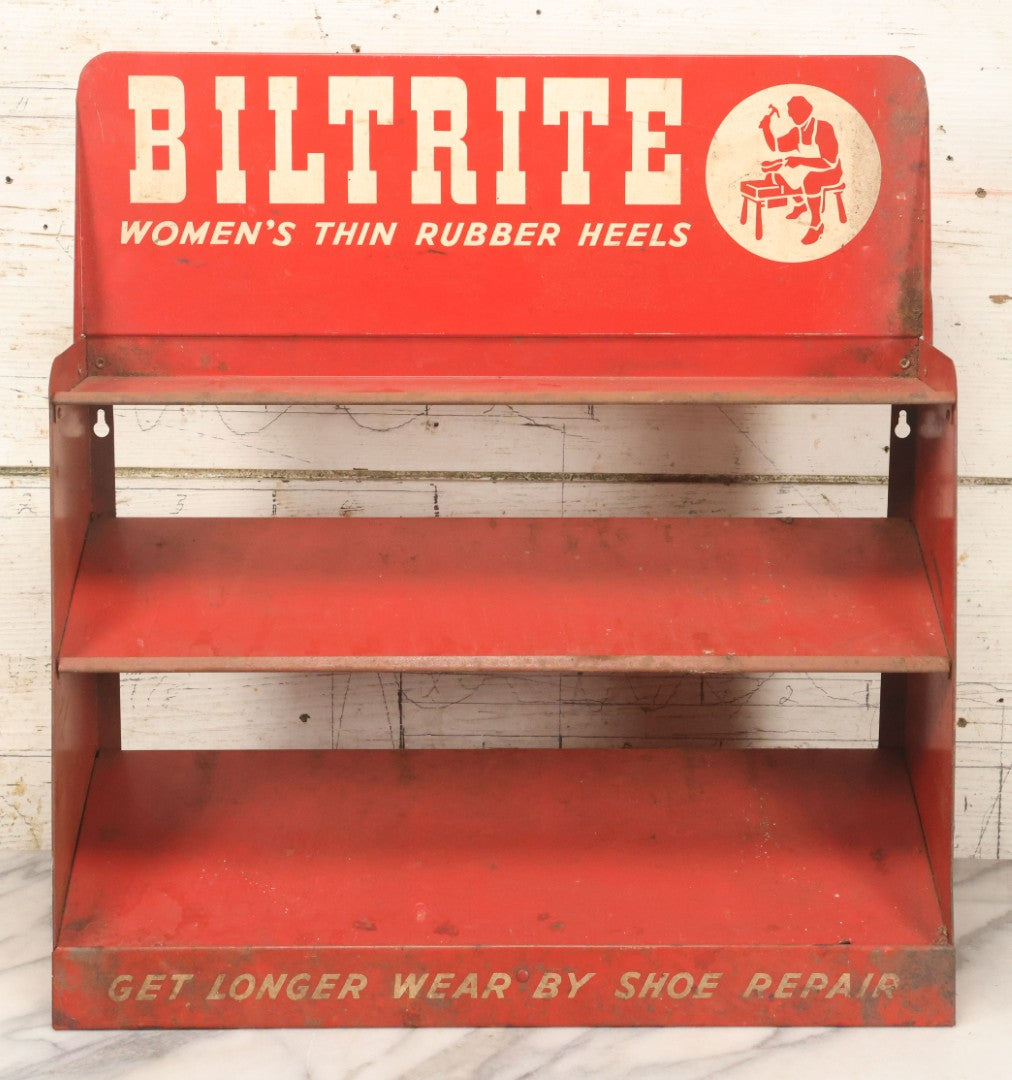 Lot 098 - Vintage Biltrite "Women's Thin Rubber Heels" Metal Shoe Repair Store Display, Red Advertising Shelf, "Get Longer Wear By Shoe Repair," Approximately 16" Wide, 17" Tall