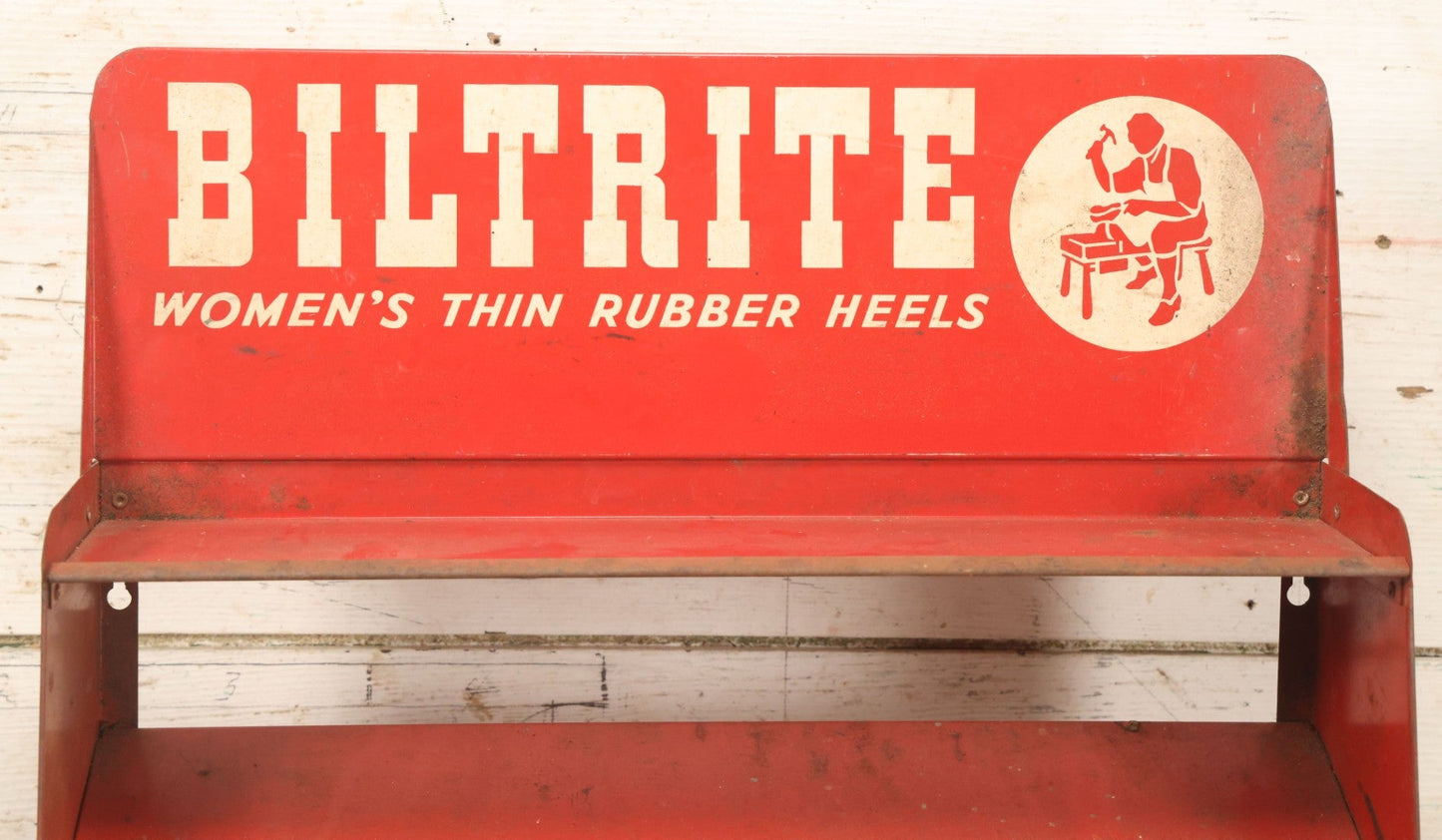 Lot 098 - Vintage Biltrite "Women's Thin Rubber Heels" Metal Shoe Repair Store Display, Red Advertising Shelf, "Get Longer Wear By Shoe Repair," Approximately 16" Wide, 17" Tall
