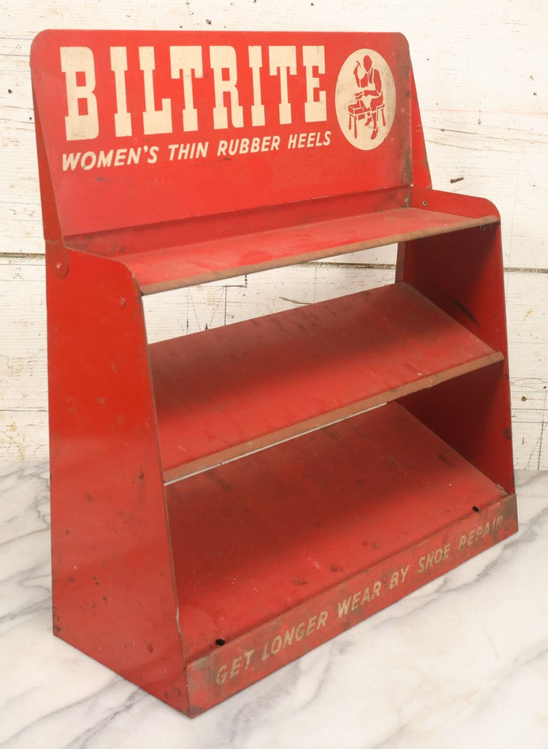 Lot 098 - Vintage Biltrite "Women's Thin Rubber Heels" Metal Shoe Repair Store Display, Red Advertising Shelf, "Get Longer Wear By Shoe Repair," Approximately 16" Wide, 17" Tall