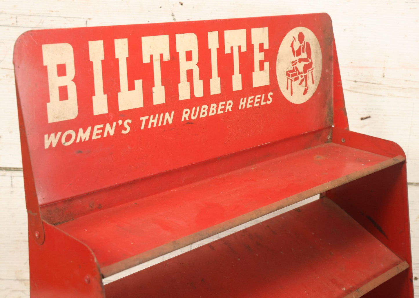 Lot 098 - Vintage Biltrite "Women's Thin Rubber Heels" Metal Shoe Repair Store Display, Red Advertising Shelf, "Get Longer Wear By Shoe Repair," Approximately 16" Wide, 17" Tall