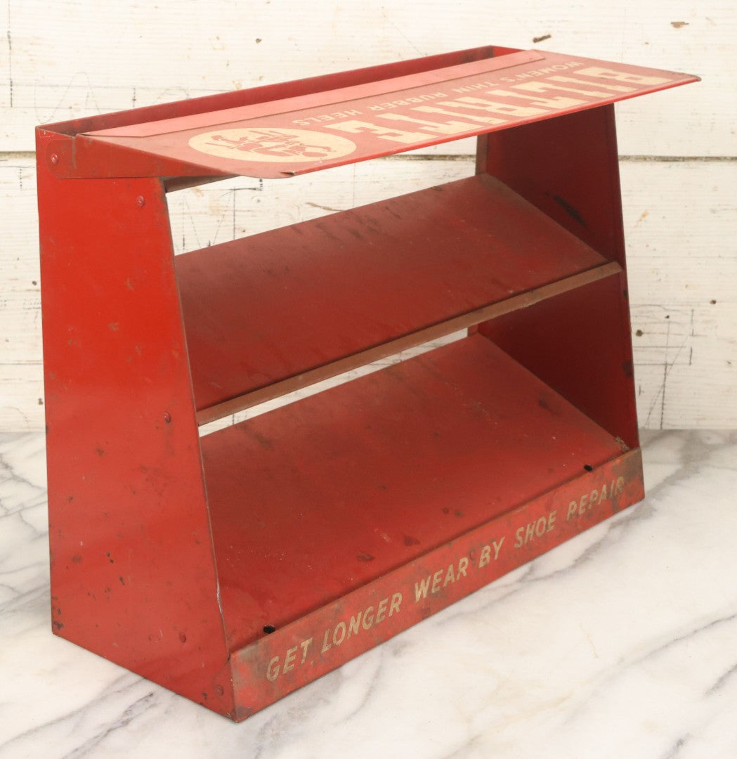 Lot 098 - Vintage Biltrite "Women's Thin Rubber Heels" Metal Shoe Repair Store Display, Red Advertising Shelf, "Get Longer Wear By Shoe Repair," Approximately 16" Wide, 17" Tall