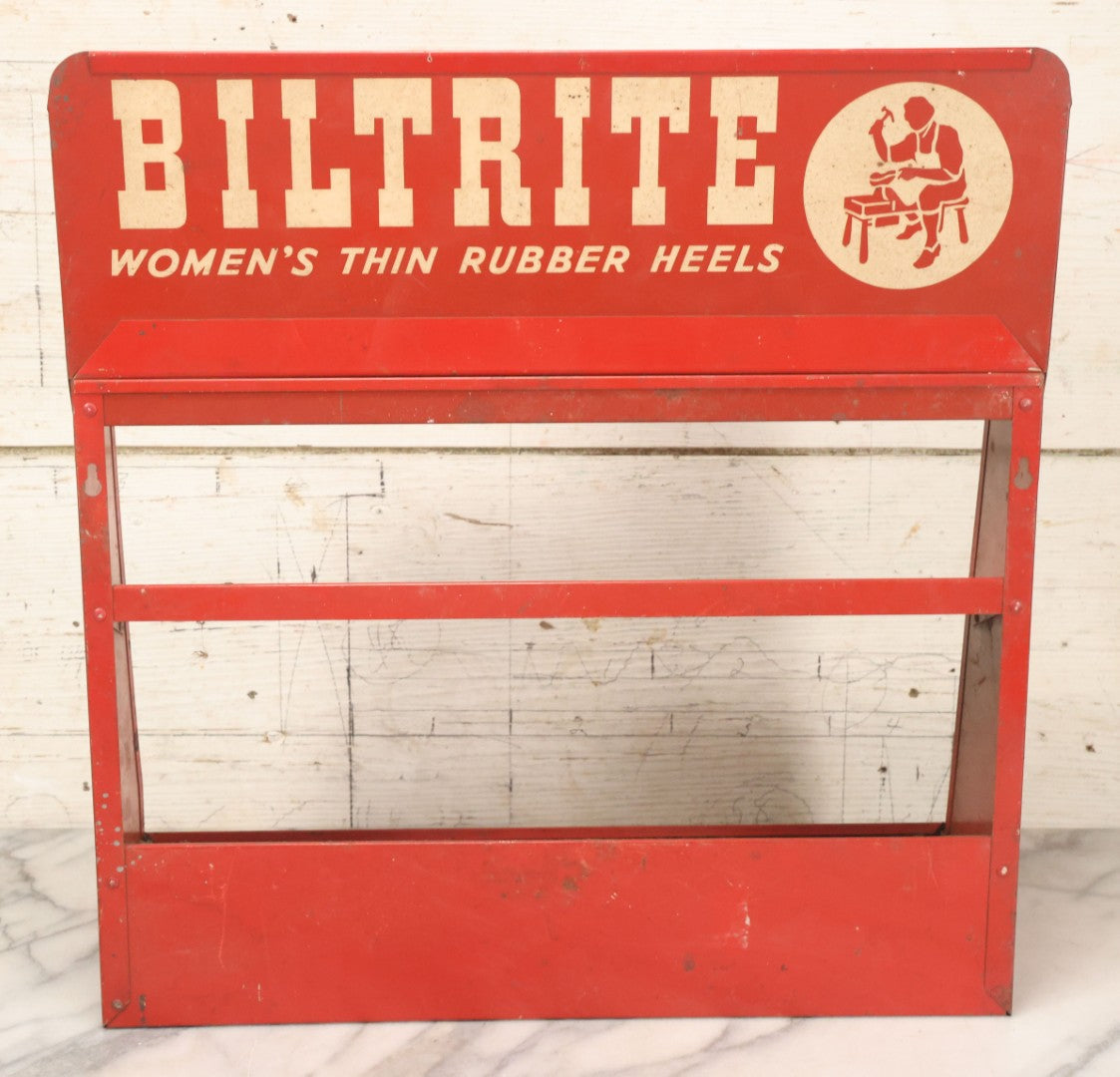 Lot 098 - Vintage Biltrite "Women's Thin Rubber Heels" Metal Shoe Repair Store Display, Red Advertising Shelf, "Get Longer Wear By Shoe Repair," Approximately 16" Wide, 17" Tall