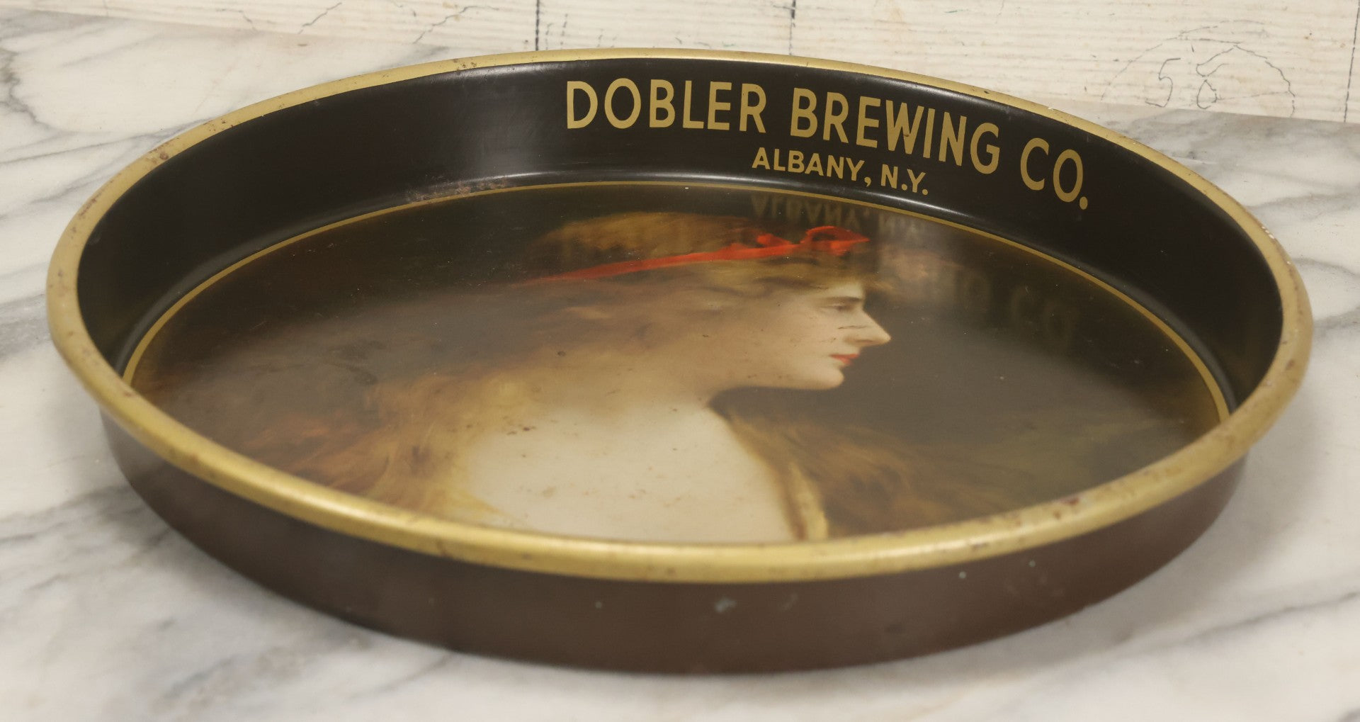 Lot 100 - Vintage Dobler Brewing Company Tin Lithograph Beer Tray With Beautiful Woman, Albany, New York, After A. Asti, 13-1/4" Diameter