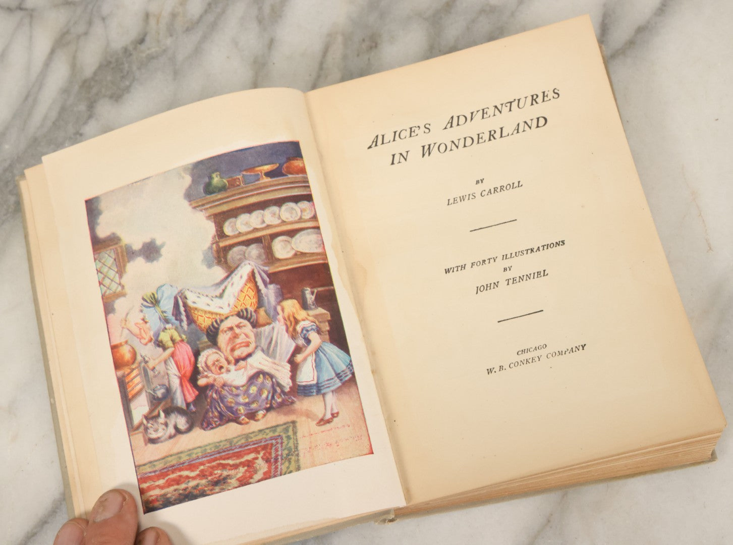 Lot 139 - "Alice's Adventures In Wonderland" Vintage Book By Lewis Carroll With 40 Illustrations By John Tenniel, W.B. Conkey, Publishers, Chicago, Early 20th Century, With Illustrated Cover, Note Slight Warping To Covers