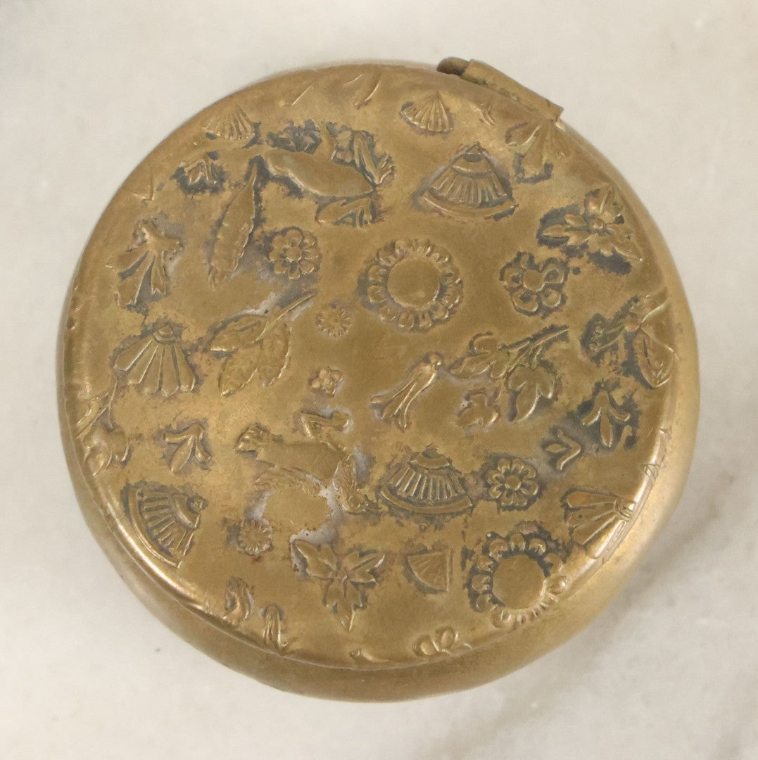 Lot 088 - Antique Small Brass Pill Pot With Hinged Lid With Flora And Fauna Decorations, Including Birds Frogs And Flowers