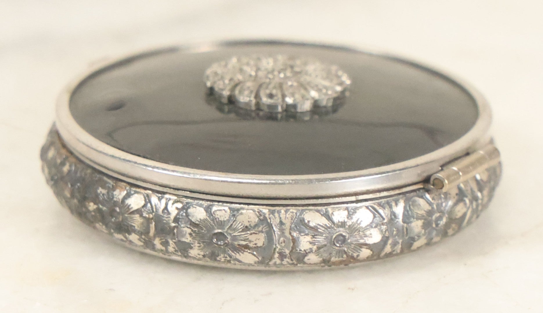 Lot 090 - Vintage Silverplate Compact With Floral Motif Edge And M.P. Monogram On Verso