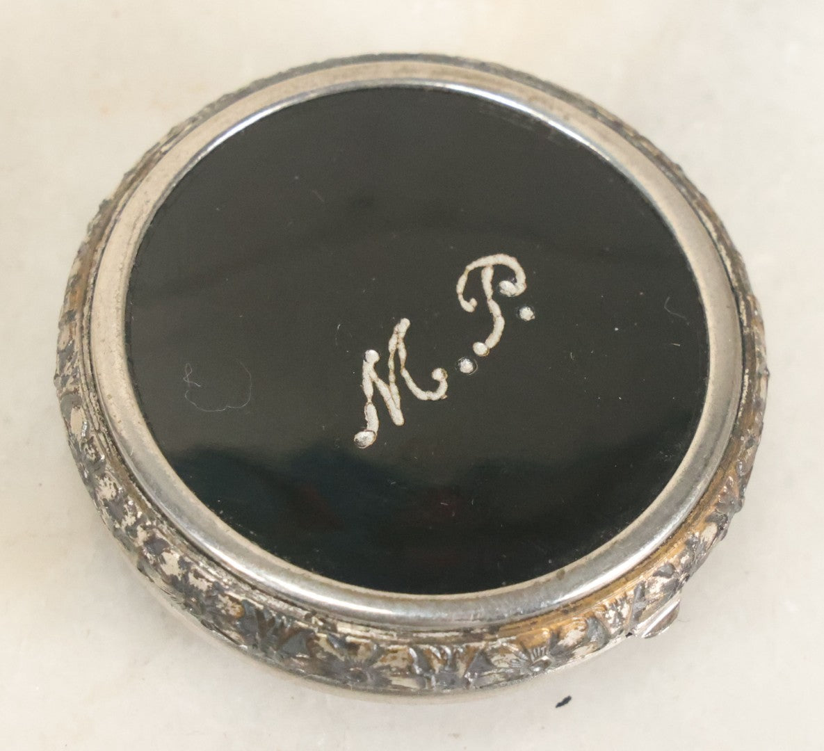 Lot 090 - Vintage Silverplate Compact With Floral Motif Edge And M.P. Monogram On Verso