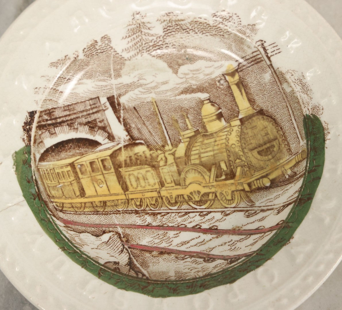 Lot 092 - Antique Transferware Child's Alphabet Plate With Locomotive Railroad Design, Makers Mark On Verso, Note Severe Crack