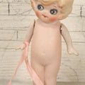 Lot 095 - Vintage Bisque Hand Painted Flapper Doll, Made In Japan, With Blond Hair And Pink Ribbon Around Wrist, Approximately 6" Height
