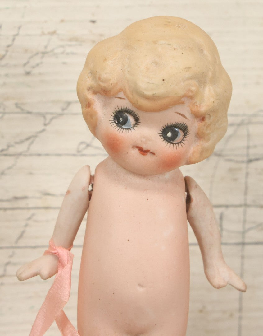 Lot 095 - Vintage Bisque Hand Painted Flapper Doll, Made In Japan, With Blond Hair And Pink Ribbon Around Wrist, Approximately 6" Height