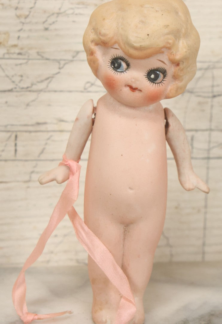 Lot 095 - Vintage Bisque Hand Painted Flapper Doll, Made In Japan, With Blond Hair And Pink Ribbon Around Wrist, Approximately 6" Height