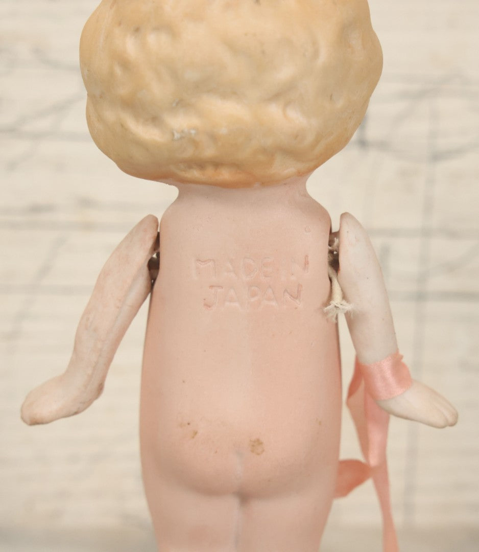 Lot 095 - Vintage Bisque Hand Painted Flapper Doll, Made In Japan, With Blond Hair And Pink Ribbon Around Wrist, Approximately 6" Height