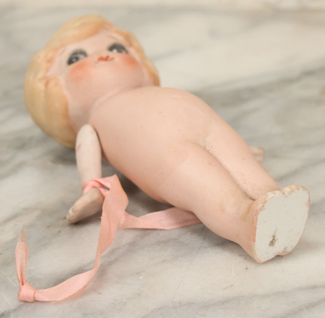 Lot 095 - Vintage Bisque Hand Painted Flapper Doll, Made In Japan, With Blond Hair And Pink Ribbon Around Wrist, Approximately 6" Height