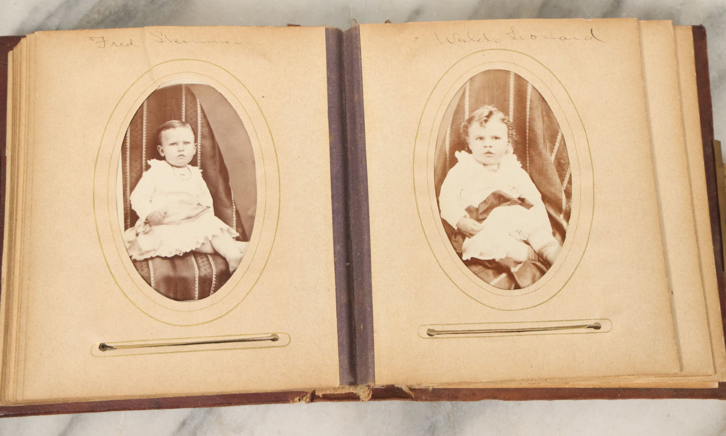 Lot 122 - Antique Cabinet Card And Tintype Family Photo Album, 10 C.D.V. Photos, 10 Tintypes, 4 Illustrated Album Filler Cards, Including Tintype Of Grandma Sherman In Mourning And C.D.V. Of Twin Girls