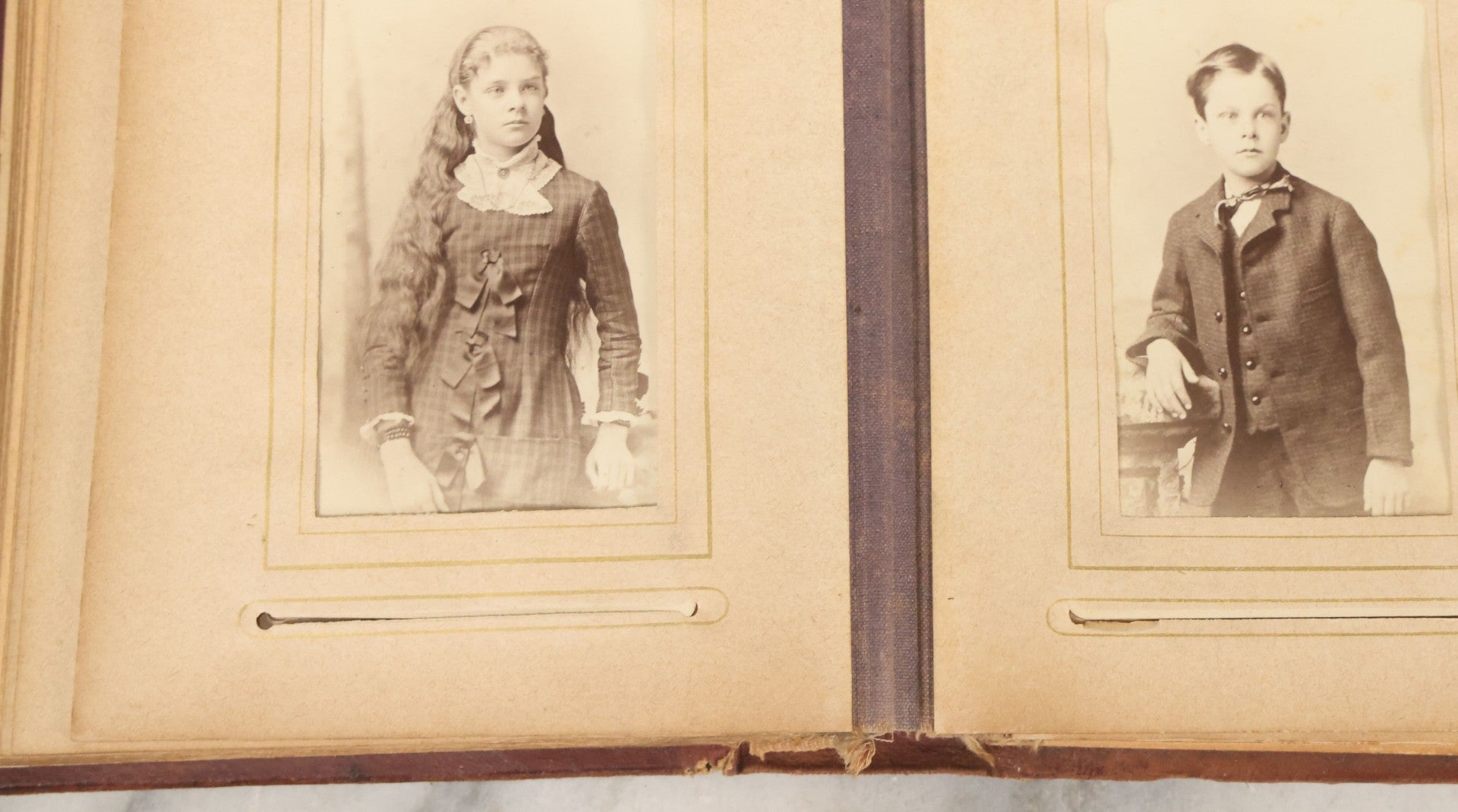 Lot 122 - Antique Cabinet Card And Tintype Family Photo Album, 10 C.D.V. Photos, 10 Tintypes, 4 Illustrated Album Filler Cards, Including Tintype Of Grandma Sherman In Mourning And C.D.V. Of Twin Girls