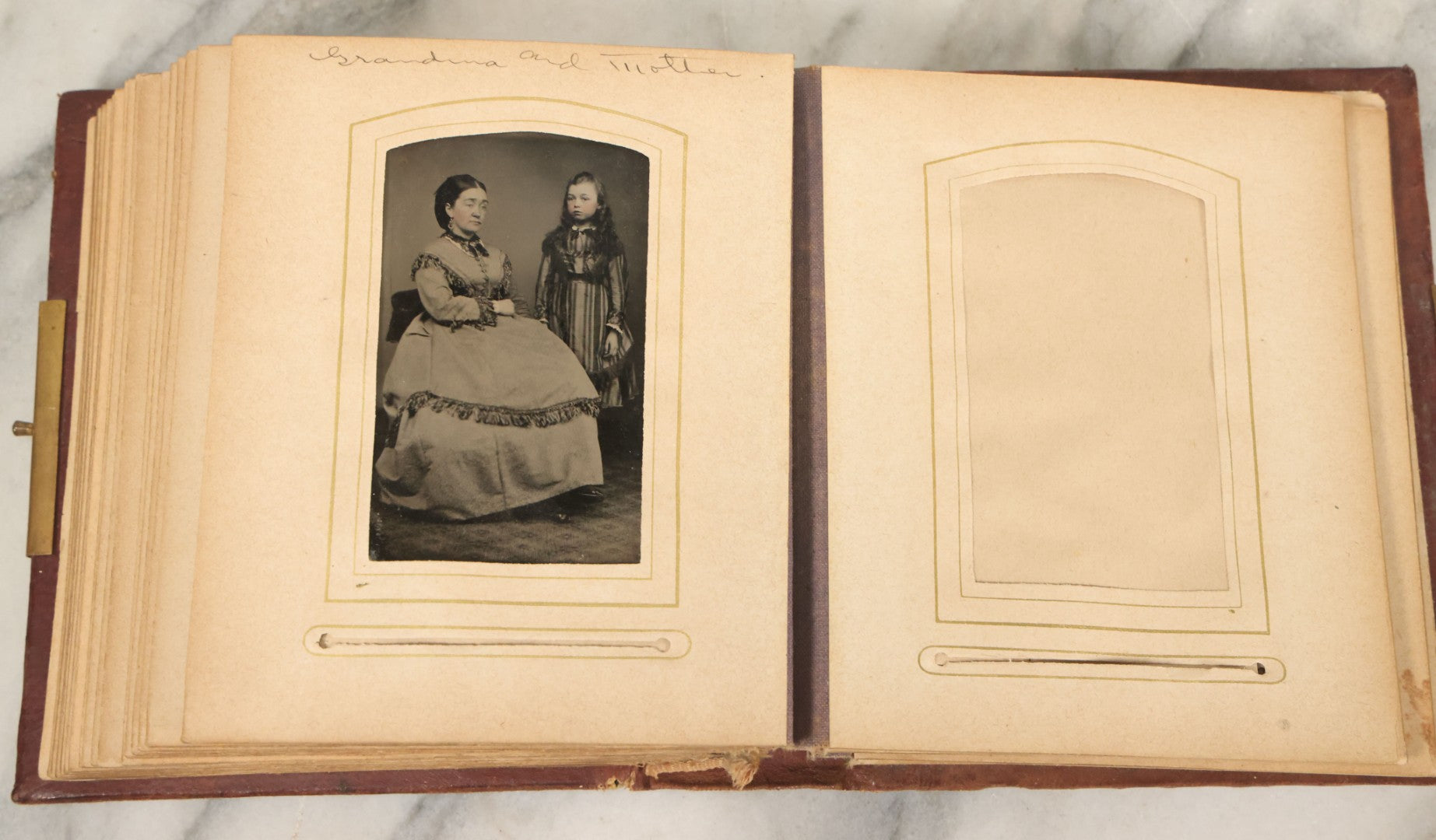 Lot 122 - Antique Cabinet Card And Tintype Family Photo Album, 10 C.D.V. Photos, 10 Tintypes, 4 Illustrated Album Filler Cards, Including Tintype Of Grandma Sherman In Mourning And C.D.V. Of Twin Girls