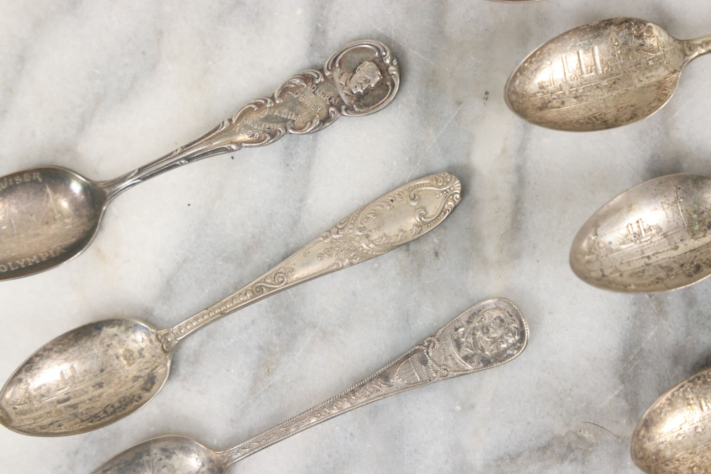 Lot 122 - Grouping Of 8 Antique Souvenir Spoons Relating To Ships And Leaders Of The Spanish American War Including The U.S. Battleship Maine, The Flagship New York, And Others, Manufactured By George E. Homer, Boston
