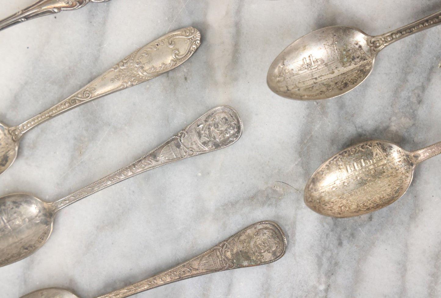 Lot 122 - Grouping Of 8 Antique Souvenir Spoons Relating To Ships And Leaders Of The Spanish American War Including The U.S. Battleship Maine, The Flagship New York, And Others, Manufactured By George E. Homer, Boston