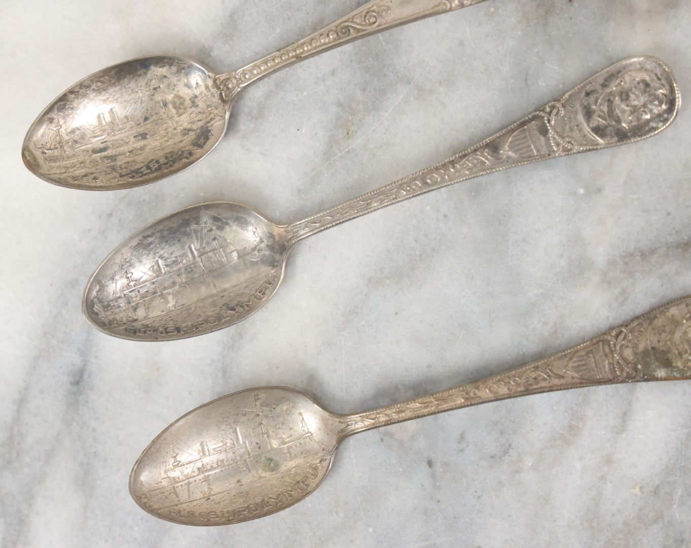 Lot 122 - Grouping Of 8 Antique Souvenir Spoons Relating To Ships And Leaders Of The Spanish American War Including The U.S. Battleship Maine, The Flagship New York, And Others, Manufactured By George E. Homer, Boston