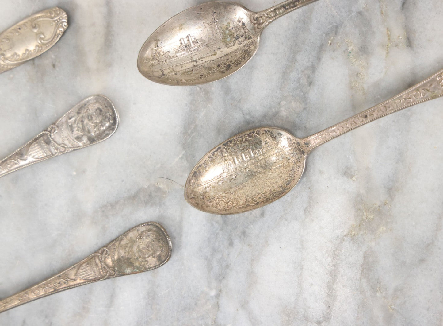 Lot 122 - Grouping Of 8 Antique Souvenir Spoons Relating To Ships And Leaders Of The Spanish American War Including The U.S. Battleship Maine, The Flagship New York, And Others, Manufactured By George E. Homer, Boston