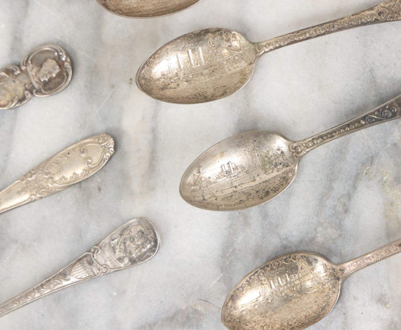 Lot 122 - Grouping Of 8 Antique Souvenir Spoons Relating To Ships And Leaders Of The Spanish American War Including The U.S. Battleship Maine, The Flagship New York, And Others, Manufactured By George E. Homer, Boston