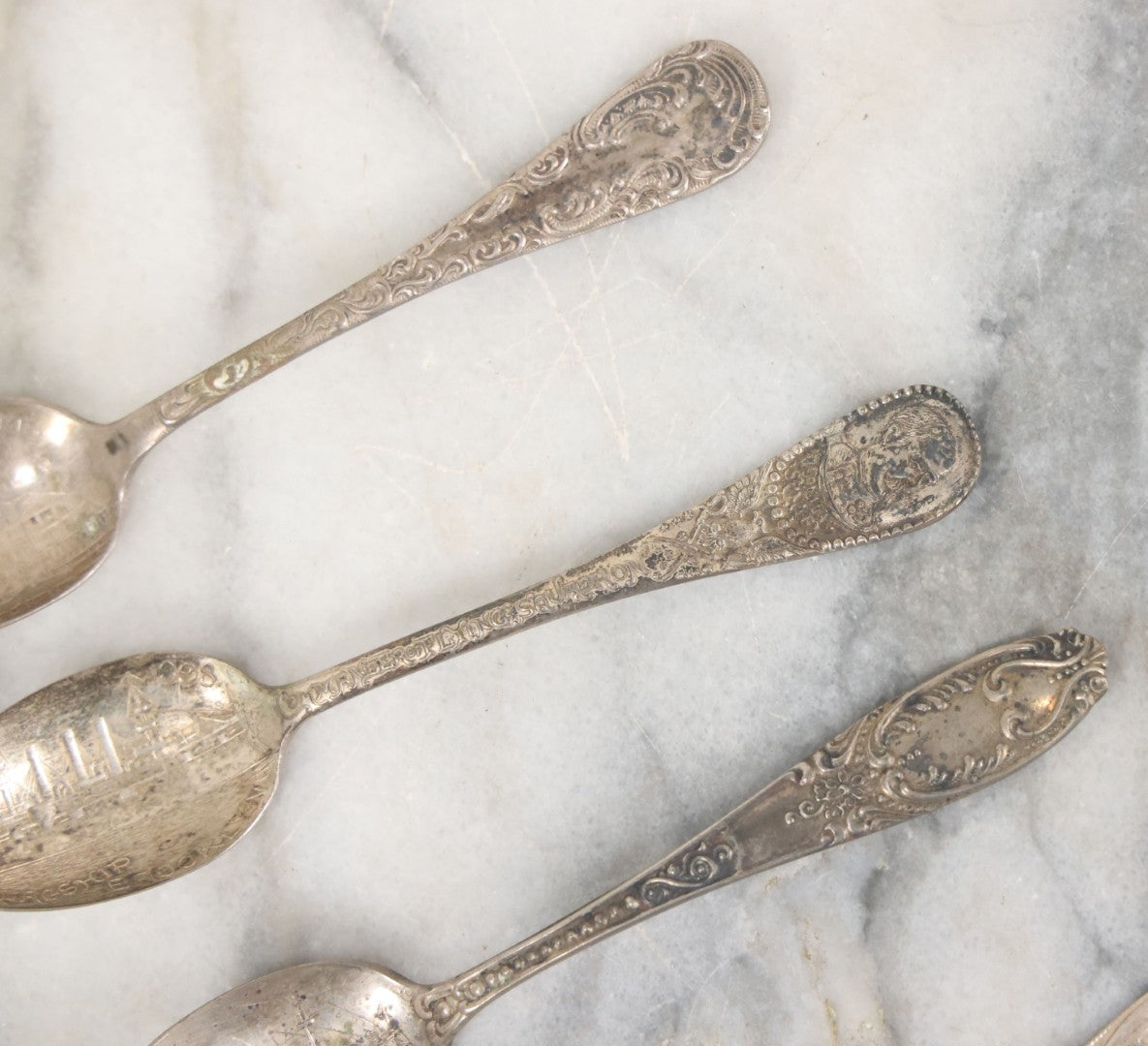 Lot 122 - Grouping Of 8 Antique Souvenir Spoons Relating To Ships And Leaders Of The Spanish American War Including The U.S. Battleship Maine, The Flagship New York, And Others, Manufactured By George E. Homer, Boston