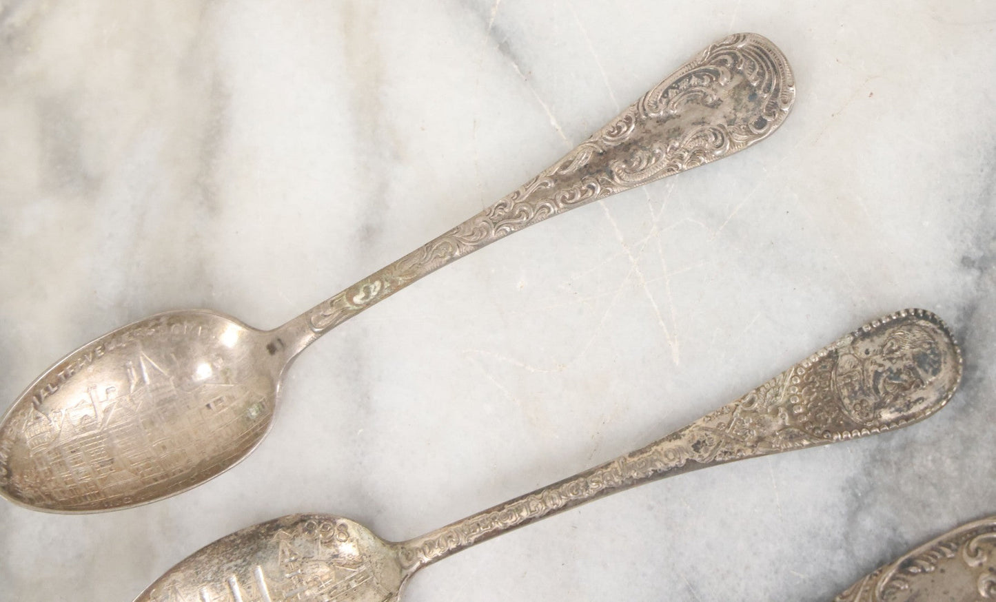 Lot 122 - Grouping Of 8 Antique Souvenir Spoons Relating To Ships And Leaders Of The Spanish American War Including The U.S. Battleship Maine, The Flagship New York, And Others, Manufactured By George E. Homer, Boston