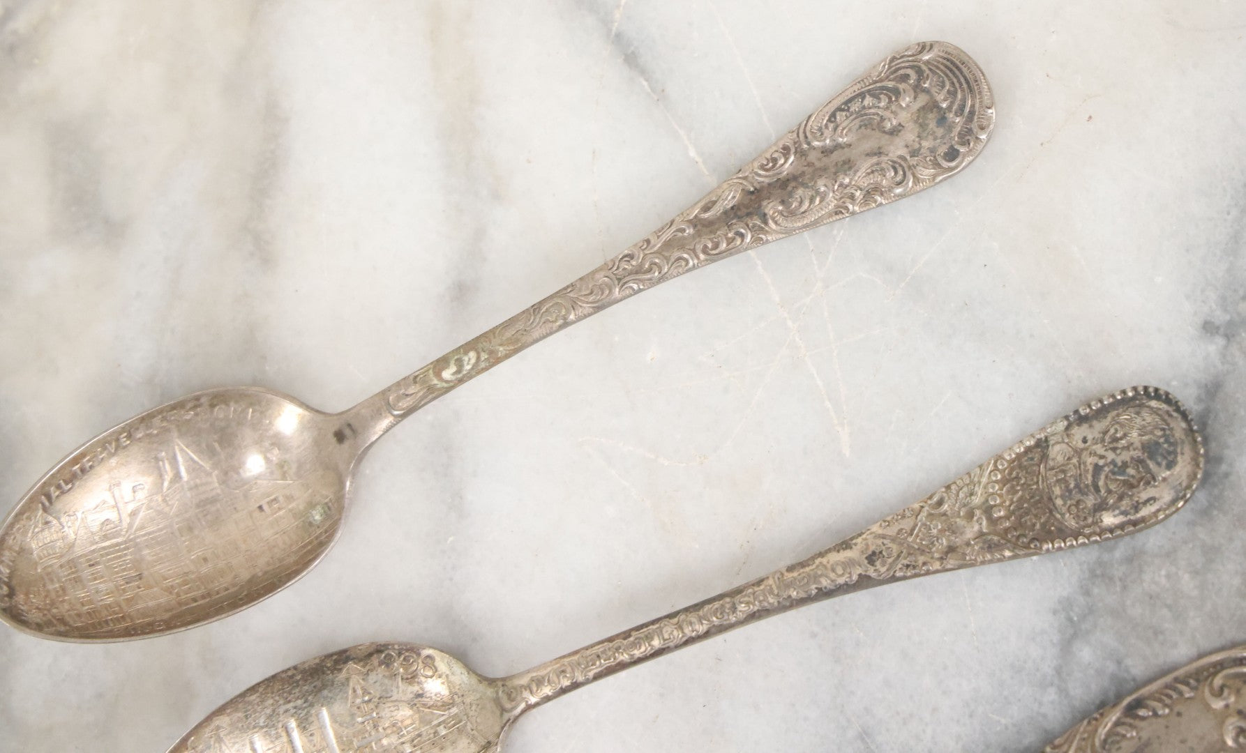 Lot 122 - Grouping Of 8 Antique Souvenir Spoons Relating To Ships And Leaders Of The Spanish American War Including The U.S. Battleship Maine, The Flagship New York, And Others, Manufactured By George E. Homer, Boston
