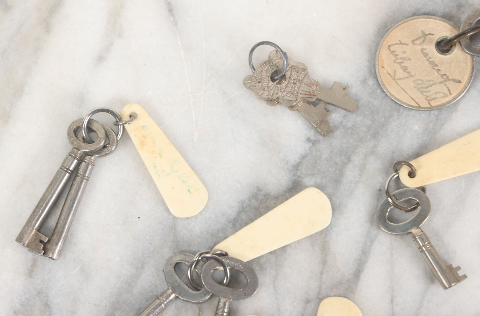 Lot 124 - Grouping Of 10+ Antique Furniture And Other Skeleton Keys With Custom Carved Bone Key Tag Keychains, Including Lucite Eagle Keychain Sold By A Deaf Mute Person