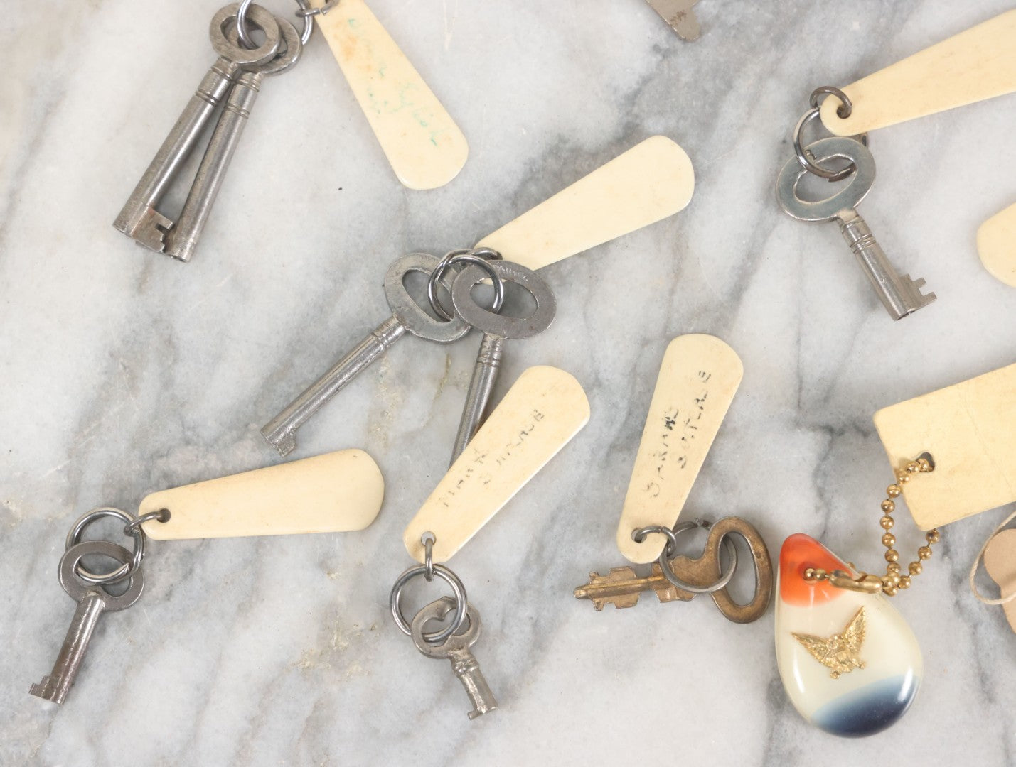 Lot 124 - Grouping Of 10+ Antique Furniture And Other Skeleton Keys With Custom Carved Bone Key Tag Keychains, Including Lucite Eagle Keychain Sold By A Deaf Mute Person