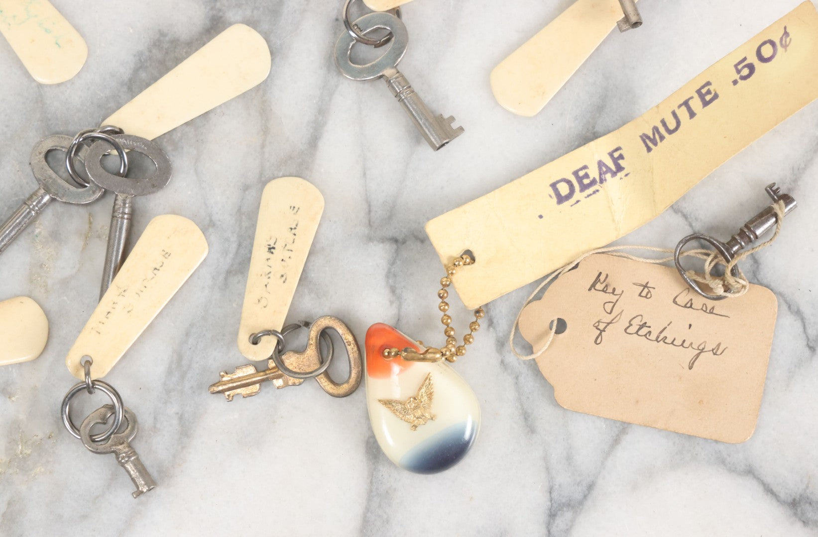Lot 124 - Grouping Of 10+ Antique Furniture And Other Skeleton Keys With Custom Carved Bone Key Tag Keychains, Including Lucite Eagle Keychain Sold By A Deaf Mute Person