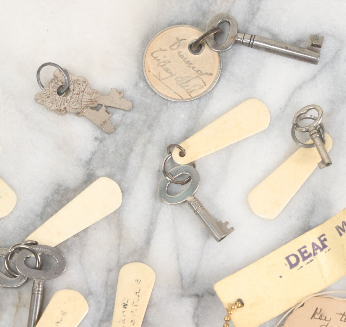 Lot 124 - Grouping Of 10+ Antique Furniture And Other Skeleton Keys With Custom Carved Bone Key Tag Keychains, Including Lucite Eagle Keychain Sold By A Deaf Mute Person