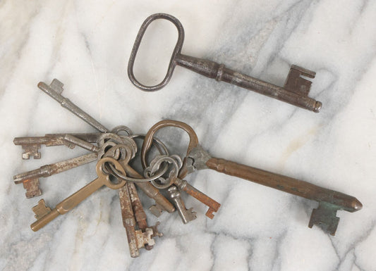 Lot 125 - Grouping Of 10+ Antique Skeleton Keys Including Two Large Gate Keys, Barrel Keys, And Others, Note One Large Key Has Crack