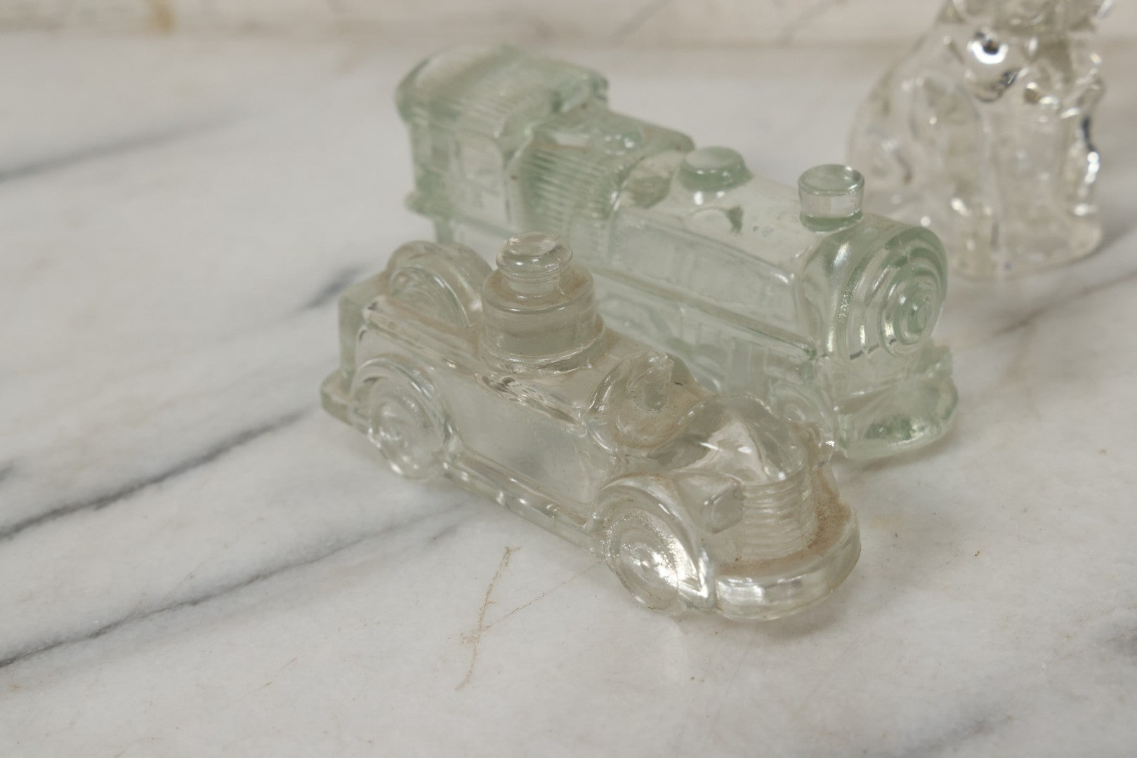 Lot 157 - Grouping Of Five Vintage Clear Glass Candy Containers Including Train, Firetruck, Two Dogs, And Military Cap Hat