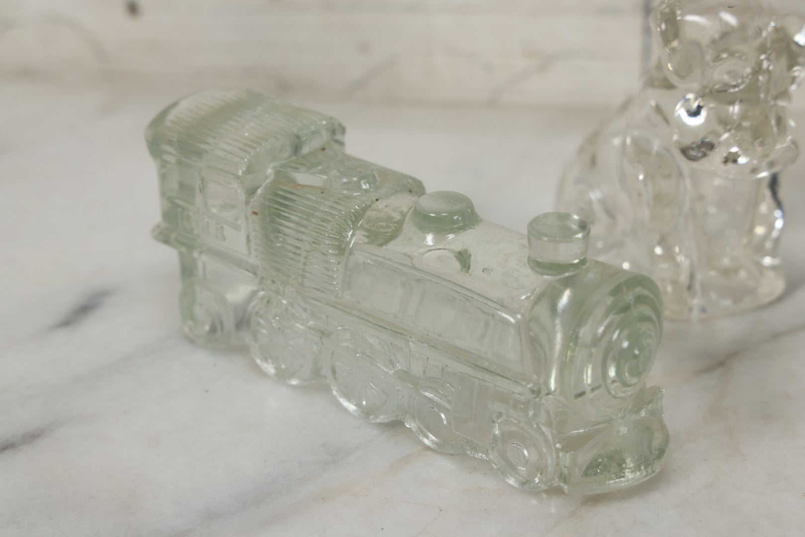 Lot 157 - Grouping Of Five Vintage Clear Glass Candy Containers Including Train, Firetruck, Two Dogs, And Military Cap Hat