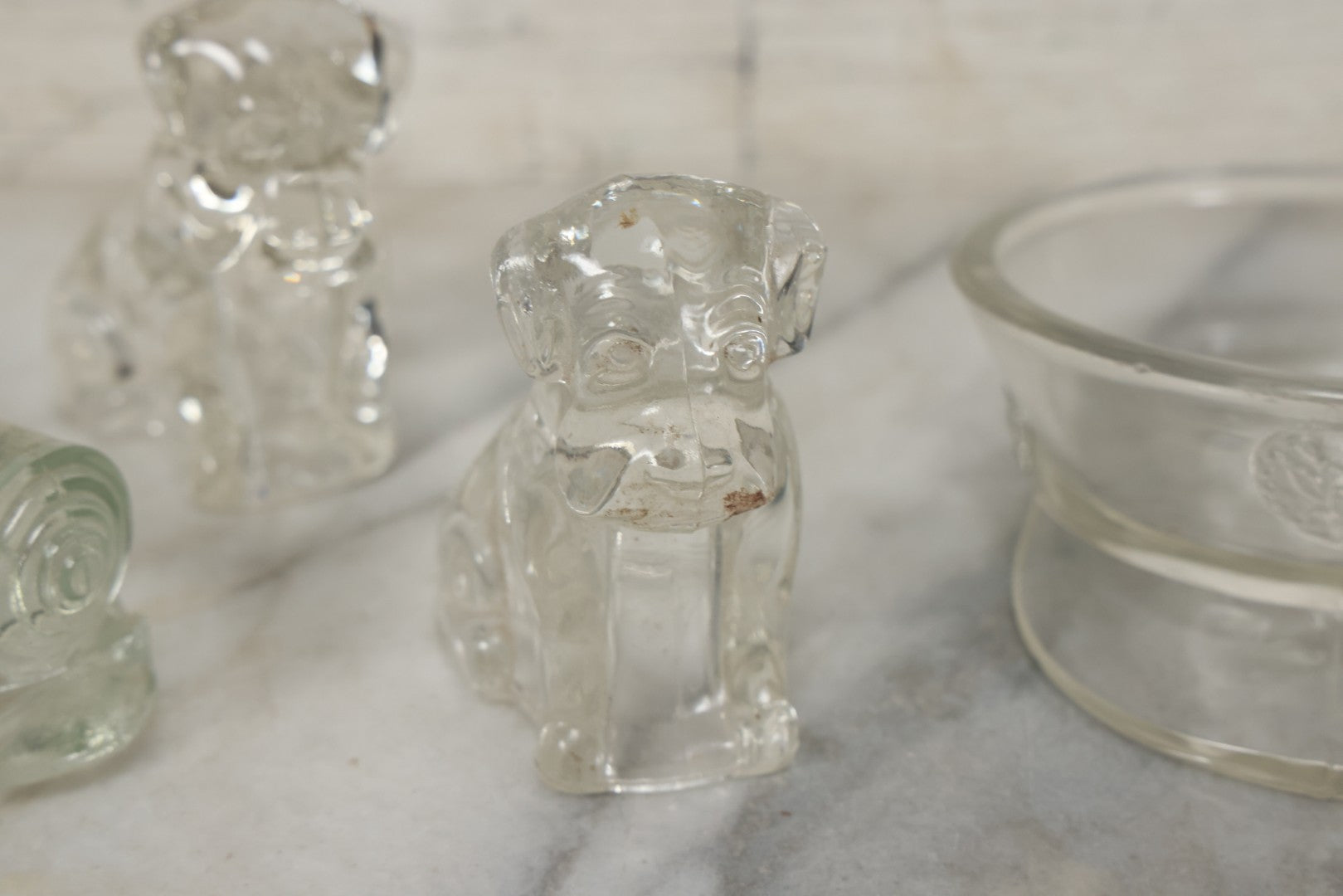 Lot 157 - Grouping Of Five Vintage Clear Glass Candy Containers Including Train, Firetruck, Two Dogs, And Military Cap Hat