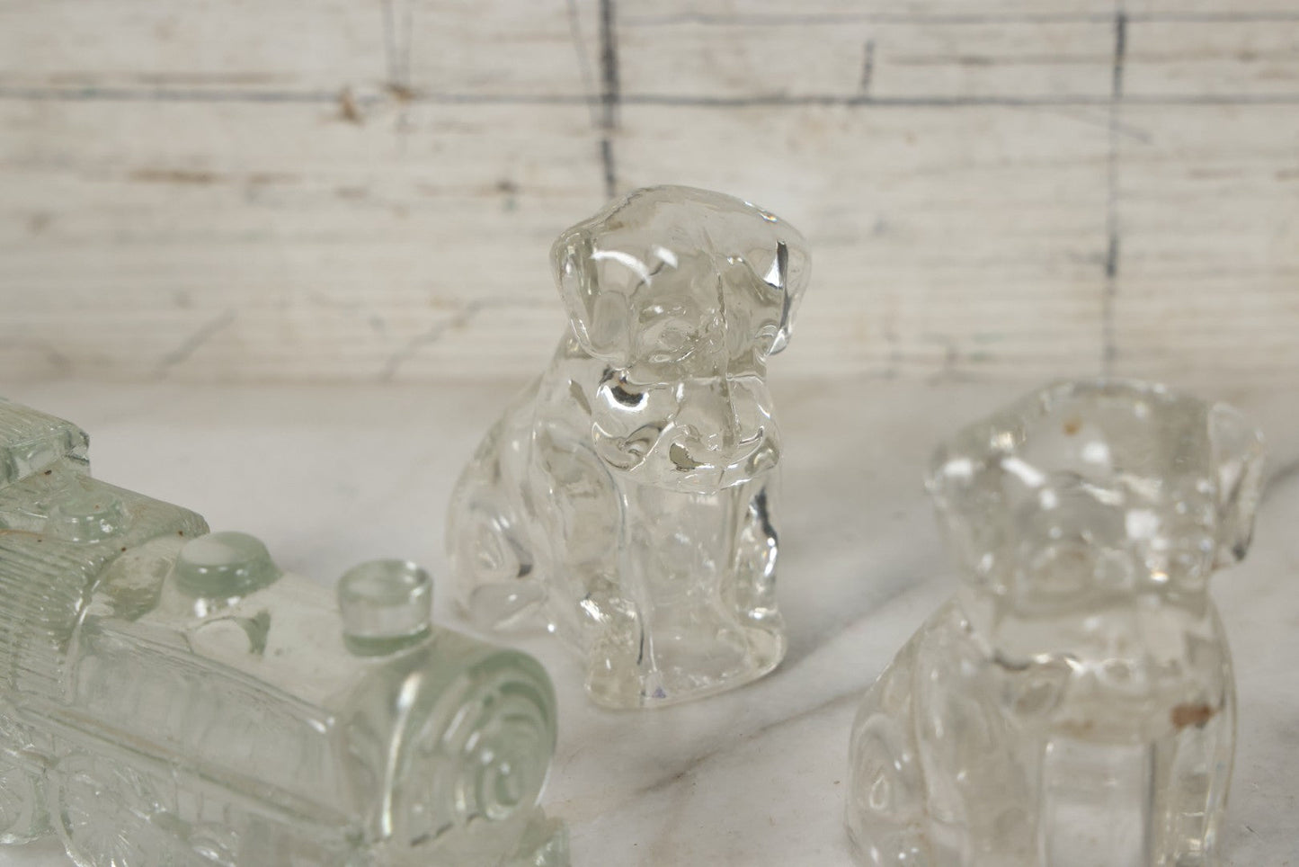 Lot 157 - Grouping Of Five Vintage Clear Glass Candy Containers Including Train, Firetruck, Two Dogs, And Military Cap Hat