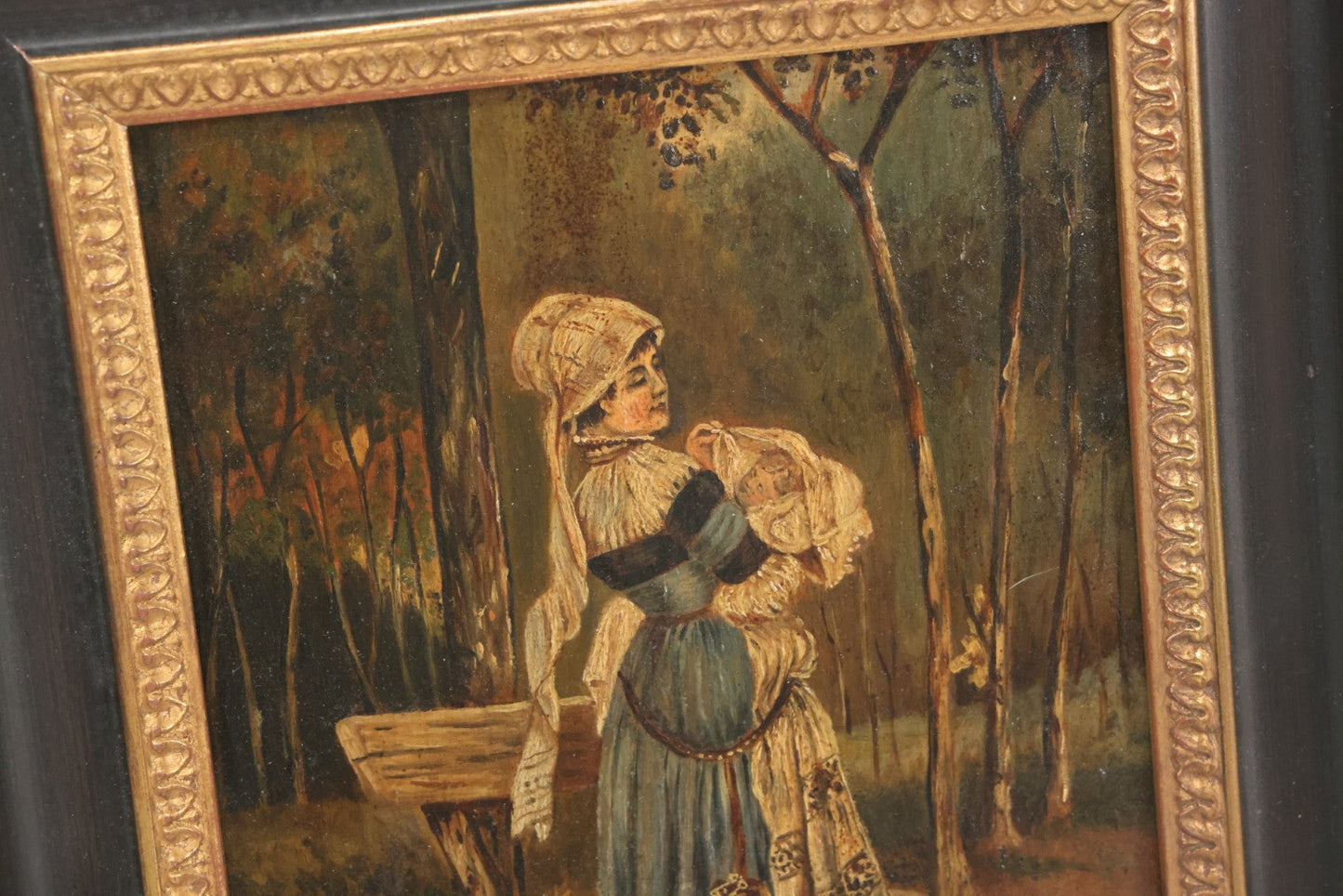 Lot 008 - Antique Painting On Wood Panel Of Victorian Woman In Blue Dress Holding Swaddled Baby By Park Bench, Unsigned, In Modern Frame, 9-1/2" x 11-7/8"