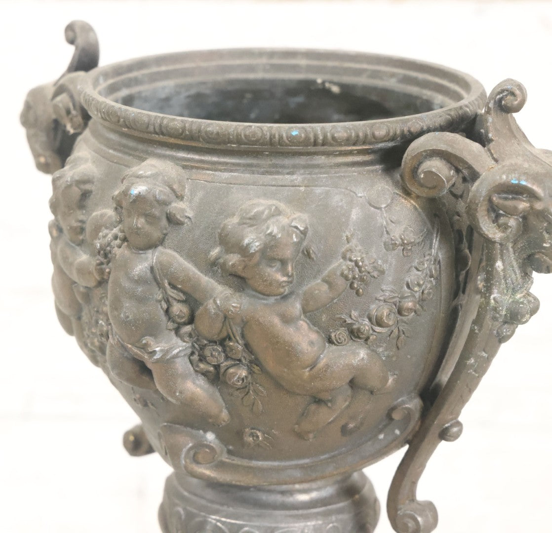 Lot 010 - Antique Ornate Cast Pot Metal Urn With Cherub And Goat Head Motifs, With Makers Mark On Bottom, Marked No. 1409, 9-1/2" High